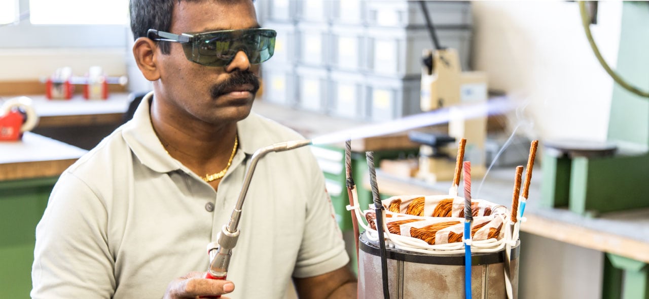 e+a USA worker assembling a induction motor